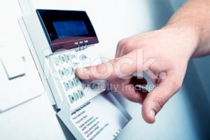 person inputting a code into a security system